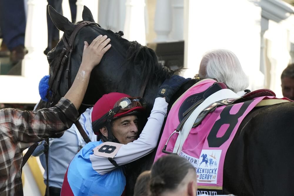 Jockey John Velazquez hugs Medina Spirit.jpeg